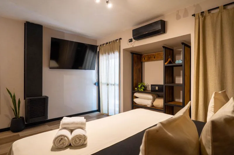 Cama de dos plazas de la Suite con Smart TV y salida al balcón